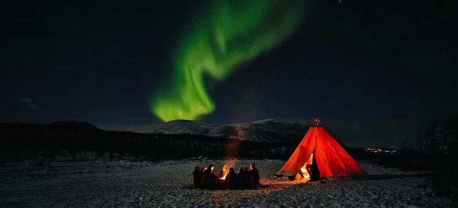 Abisko: Northern Lights Hike with Husky Puppies - A fire, hot drink, and Arctic stories in the lávvu