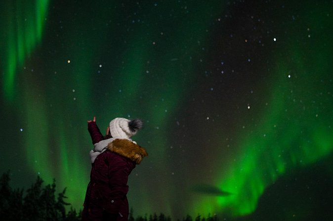 Northern Lights Reindeer Sledge Ride - Warming up beside the kota fire